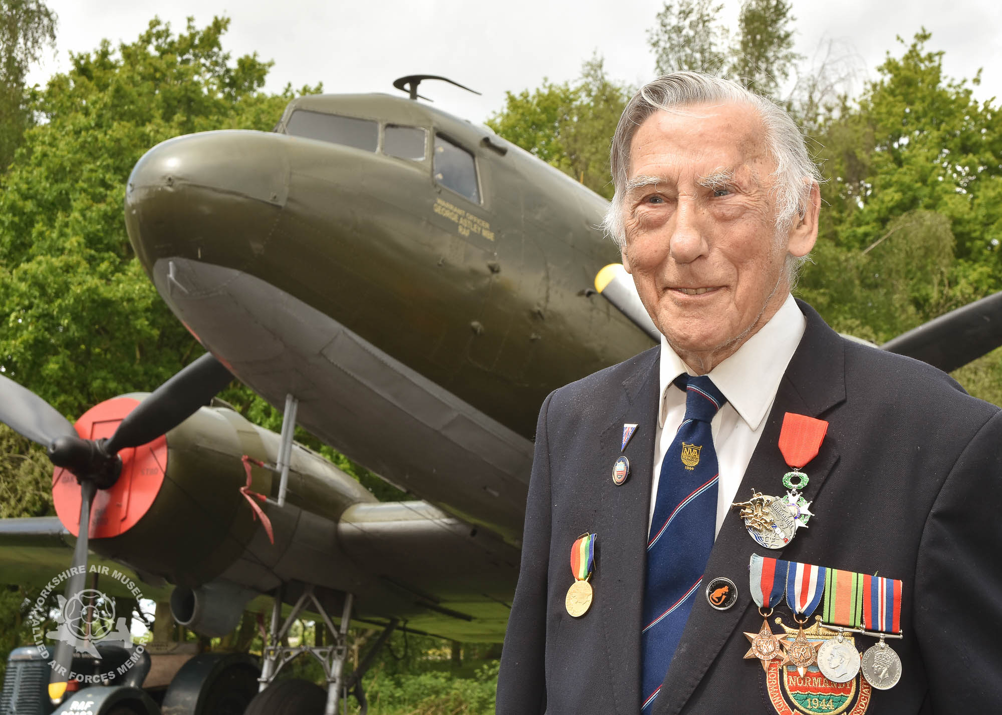 Pictured in front of a Dakota transport aircraft like the one in which he was evacuated from France after being wounded is Horace Hodgson. Legion d'Honneur medals presented to 21 Normandy Veterans at Yorkshire Air Museum on Sunday 22nd May, 2016. Pictured is Horace Hodgson of manor Mount, Leeds, who recieved the medal from Colonel Bruno Cunat, French Liasion Officer to the Ministry of Defence. Picture David Harrison/ Yorkshire Air Museum. (Rifleman, Rifle Brigade. Landed Gold Beach and on to Bayeux, Caen, Falaise to the River Seine where he was wounded in the head) 